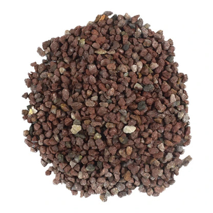 Muestra en primer plano de los granos de grava natural marca Lomas color mármol rojo vino, en Kamalitas.