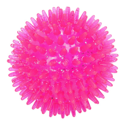 Pelota para perro color rosa translúcido con glitter y textura de picos suaves para masaje de encías.