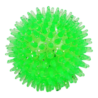 Pelota verde brillante con glitter y picos flexibles de material TPR no tóxico para estimulación de perros.